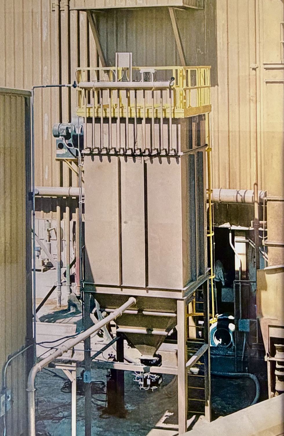 Tall CPE Filter Systems pulse jet collector installed in-plant with access platform and hopper discharge